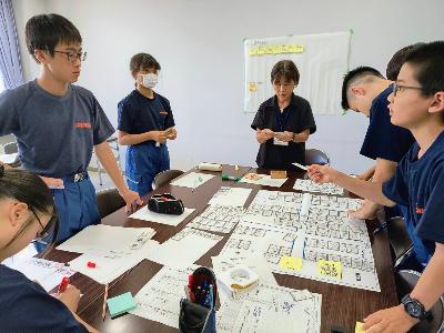 避難所運営ゲームをする少年消防団員